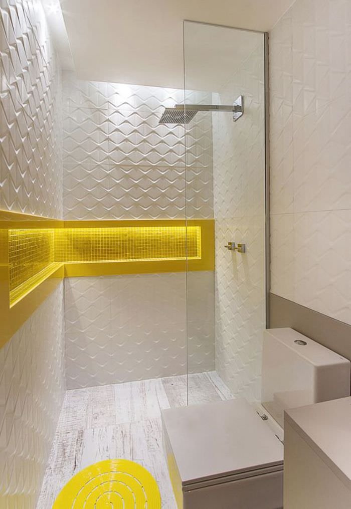 Small bathroom project with 3d tiling and L-shaped recess covered in yellow mosaic, the focal point of the room.  Ideas to renovate small bathrooms.