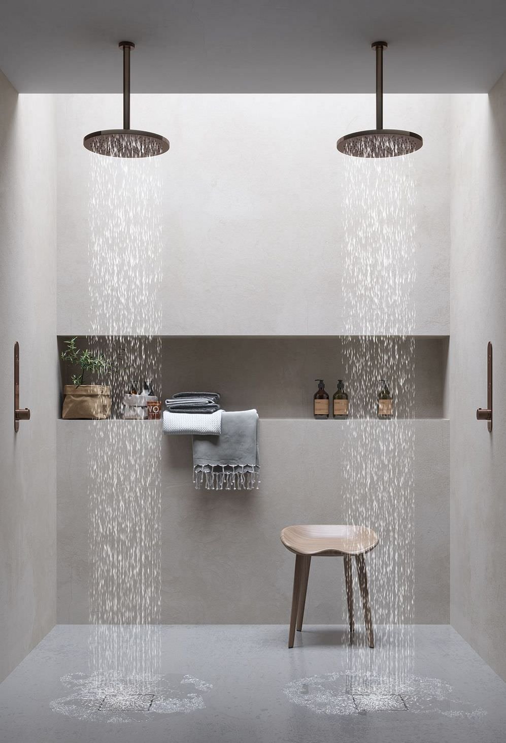 Beautiful minimal modern bathroom with walls covered in resin.  Niche along the central wall, very useful and functional.  Brass taps and shower head.