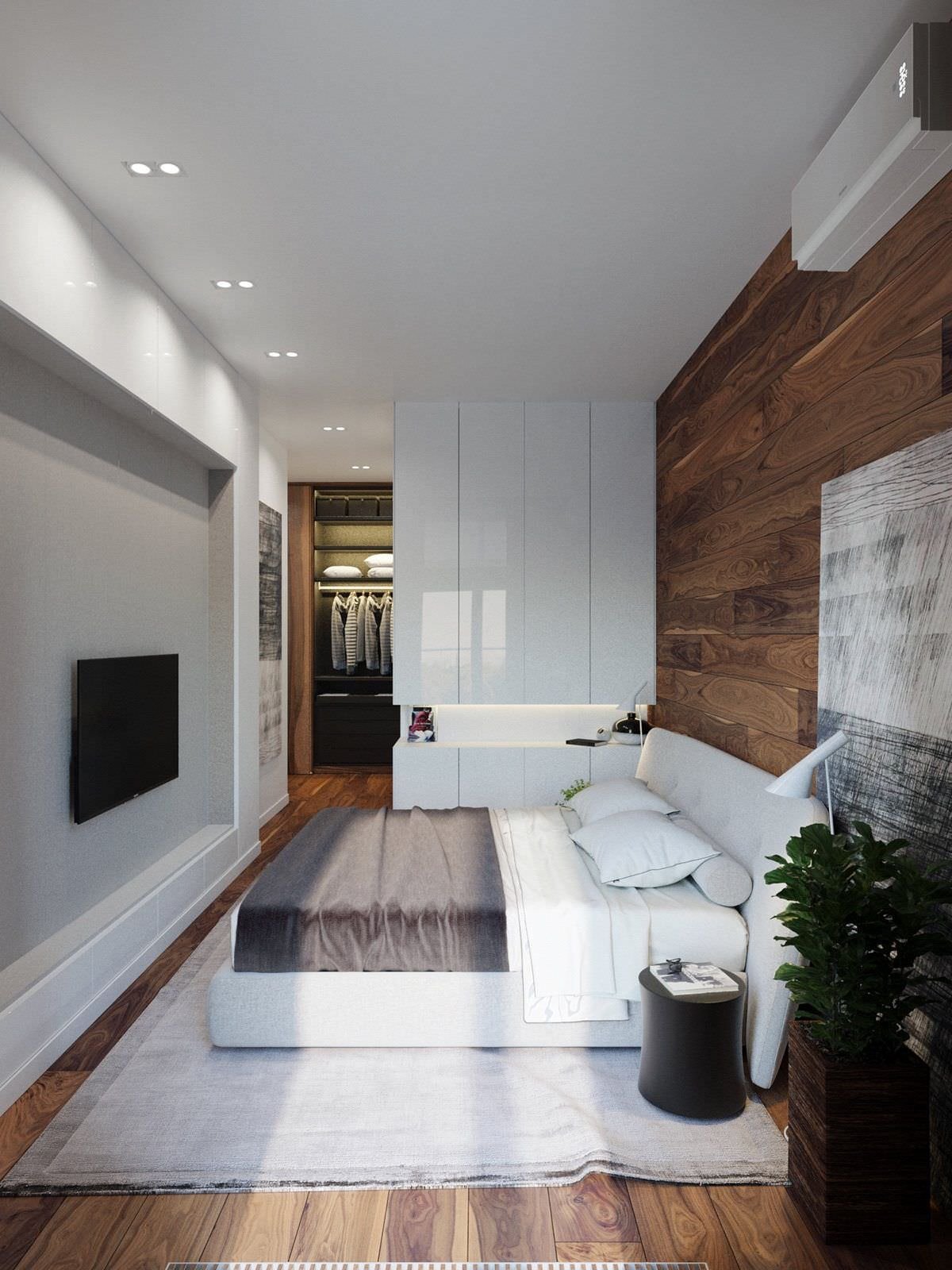 Modern bedroom with oak plank flooring that continues as a covering on the headboard wall, creating a perfect symmetry with the white wall and ceiling.