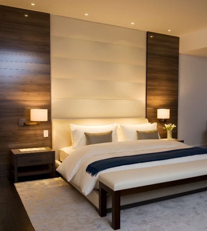 Elegant and refined room with a fabric headboard.  Modern contemporary style