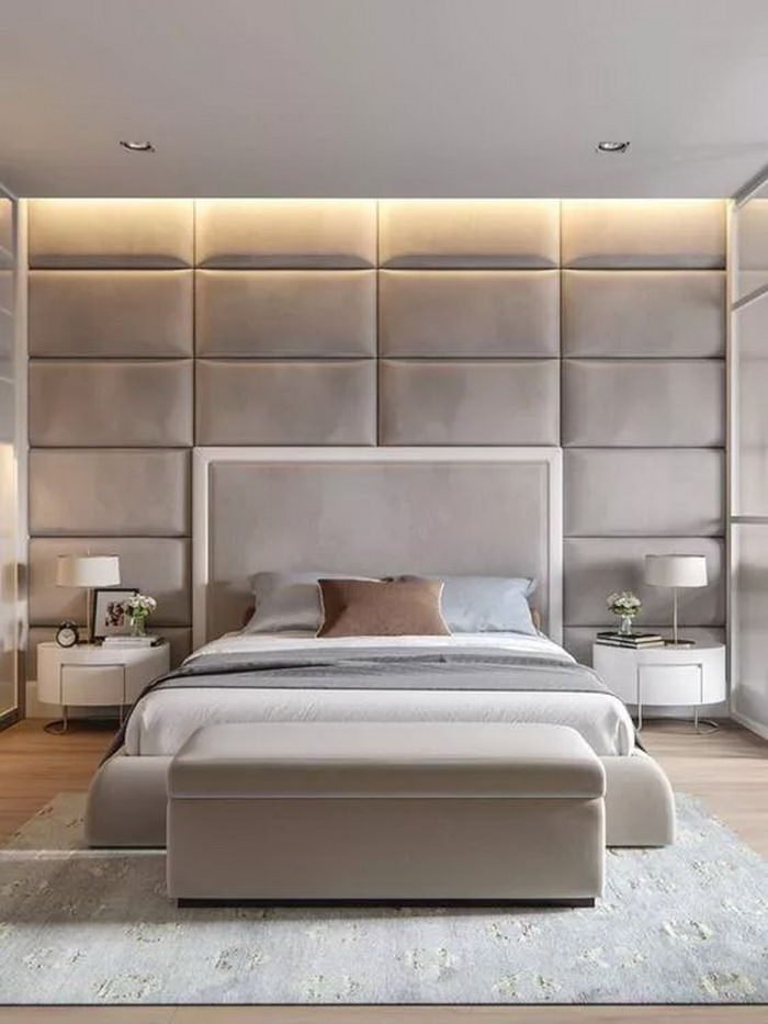 Modern bedroom in shades of beige with a fabric headboard that gives a great sense of welcome.  LED diffused light in the plasterboard ceiling.  Parquet and carpet.