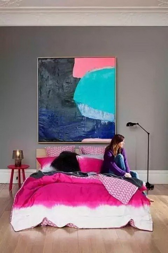 Modern feminine bedroom in bold colors, dominated by a large abstract painting positioned above the headboard - dove gray wall color