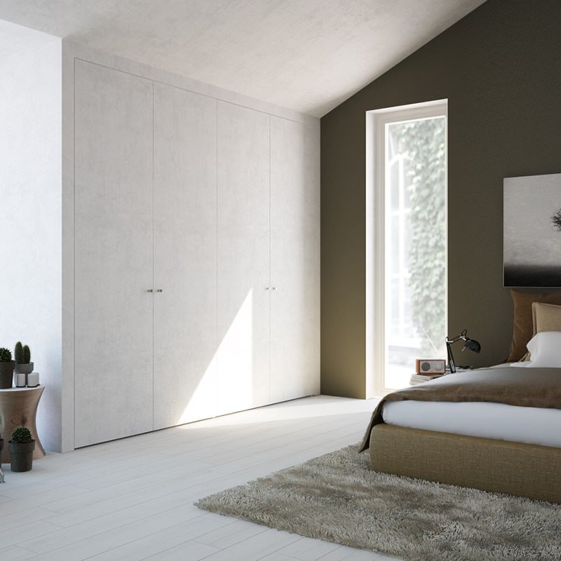 Dettaglio camera da letto con cabina armadio in cartongesso, filomuro, con ante appena percettibili. Stanza stile contemporaneo in tonalità di marrone.
