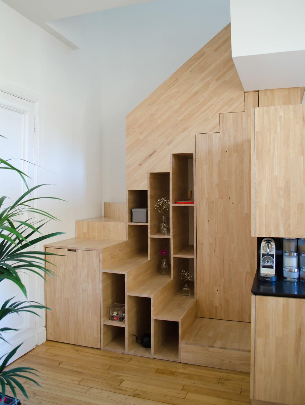 Scala in legno realizzata per sfruttare uno piccolo spazio - sono state ricavate una libreria, un armadietto e una scarpiera nell'angolo